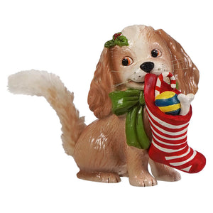 A charming bethany lowe figural decor of a brown and white cavalier king charles spaniel with a green bow holding a christmas stocking