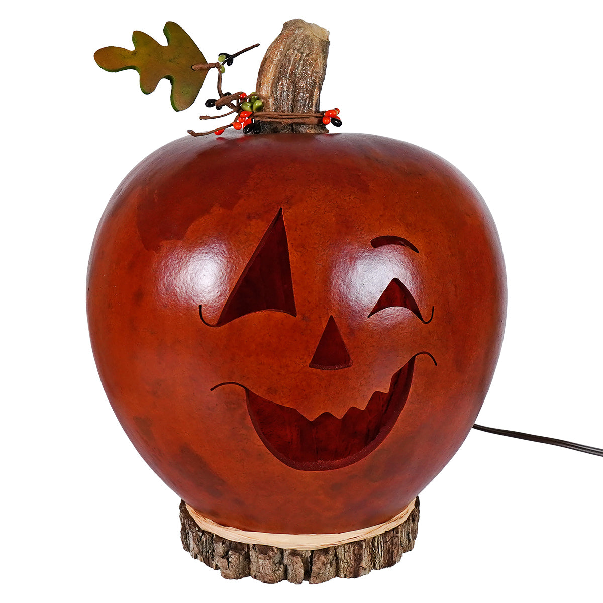 Carved large lighted jack o lantern gourd by meadowbrooke gourds artisans glowing in warm orange light