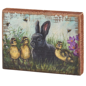 Decorative wooden box art featuring a black rabbit with baby ducks in a springtime scene.