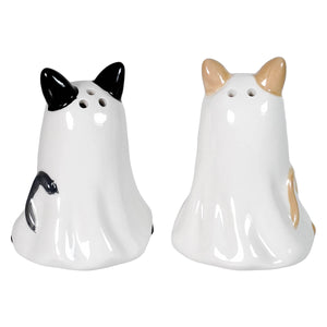 A pair of glossy white ceramic halloween salt and pepper shakers shaped like cats with black and tan markings