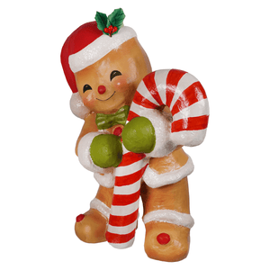 A cheerful gingerbread george figurine by bethany lowe designs wearing a santa hat holding a striped candy cane gingerbread decor