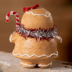 A festive gingerbread girl ornament with speckled tan body white icing and red silver tinsel from bethany lowe designs gingerbread decor