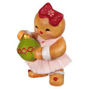 A gingerbread joy figurine by Bethany Lowe Designs features a gingerbread girl with a bow tutu and Christmas ornament