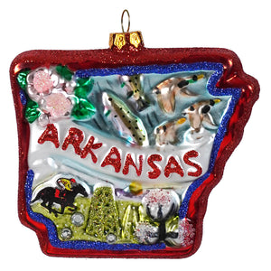 A glittery red and blue glass arkansas state ornament with fish ducks horse rider cotton bolls and pink flowers details
