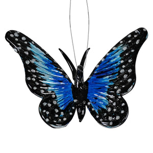 Black and blue butterfly with spotted wing patterns.