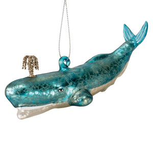 A translucent teal glass blue whale ornament with a shimmering finish and golden glitter palm tree, perfect gray whale ornament or fish and marine life decor