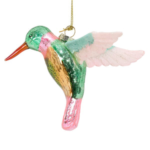 Colorful glass hummingbird ornament with green head pink and gold body translucent wings and an orange beak