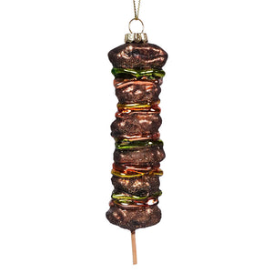 Glass Christmas ornament shaped like a kebab skewer with various meats and vegetables.