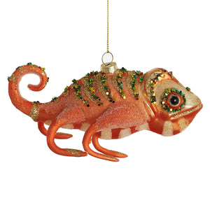 A vibrant orange glass lizard ornament with sparkling green and gold sequins detailed eye and curled tail animal ornament