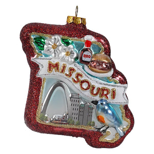 Red glittery glass missouri state ornament with white banner, gold lettering, and decorative travel and location themed details