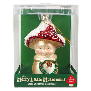 A cheerful mushroom glass ornament with a red polka dot cap and fluffy white rim holding a wreath, perfect figural decor