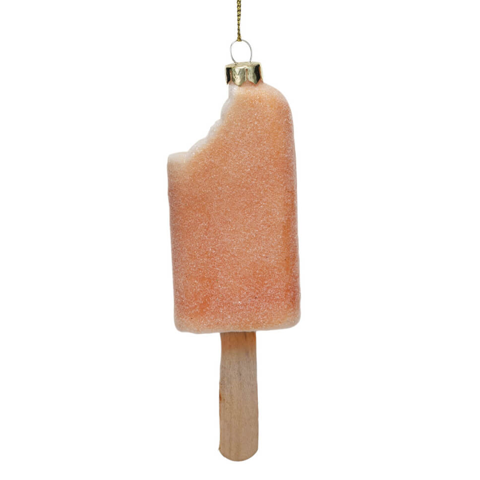 Peach-colored popsicle-shaped Christmas tree ornament.