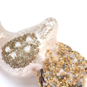 Glass pelican ornament made of glittery pink resin with gold beads and pearls, perfect for sea and beach themed ornaments