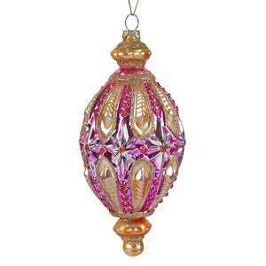 Glass pink and gold vintage finial ornament with intricate floral design hanging as a vintage reflector and indent ornament