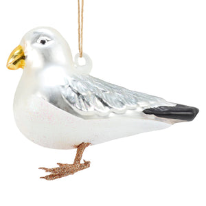 A shiny silver glass seagull ornament with a gold beak black-tipped wings perfect for sea and beach themed ornaments