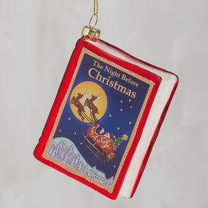 Red glass storybook ornament shaped like a book with classic holiday the night before christmas cover art
