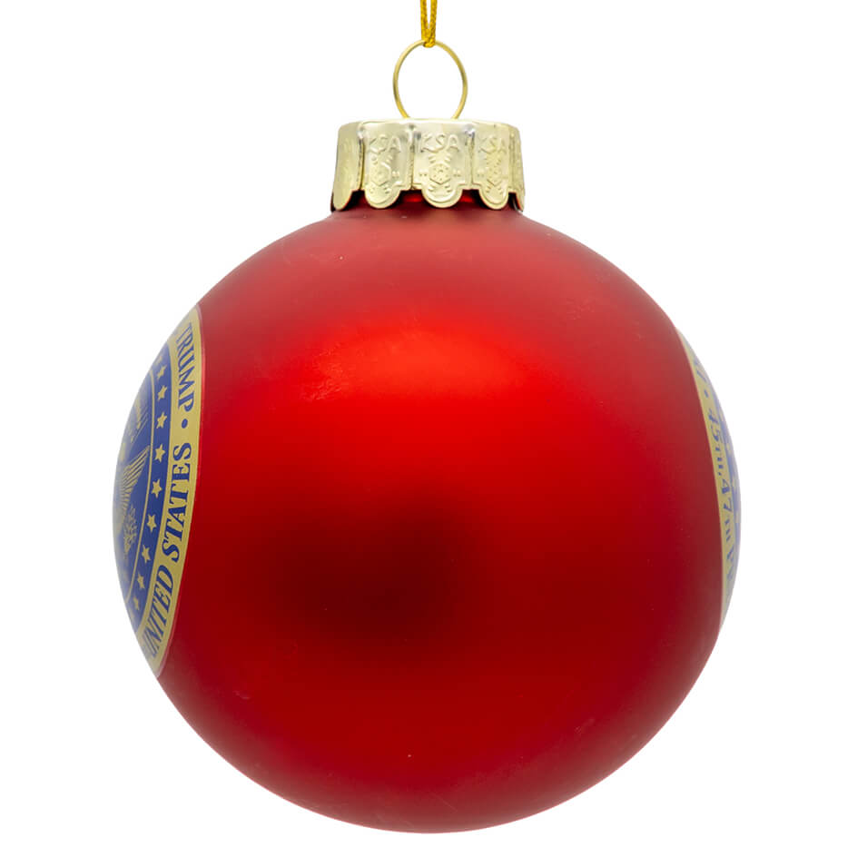 Glossy red glass trump ball ornament with gold cap and blue white us seal band kurt adler ornament