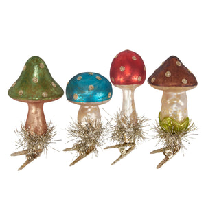 Four colorful glass vintage mushroom valentine’s day ornaments with glitter dots metallic stems and gold tinsel bases