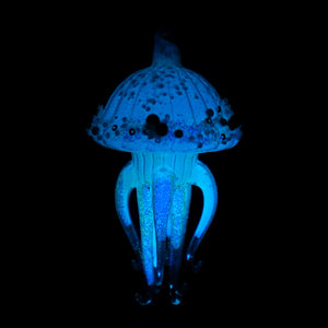A glowing blue dark glass jellyfish ornament with translucent speckled tentacles by kurt adler