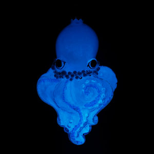 A glowing blue dark glass octopus ornament with detailed eyes and tentacles perfect as a glass octopus ornament