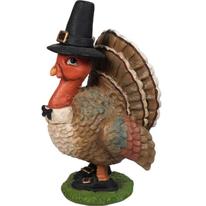 Decorative turkey figurine wearing a pilgrim hat.
