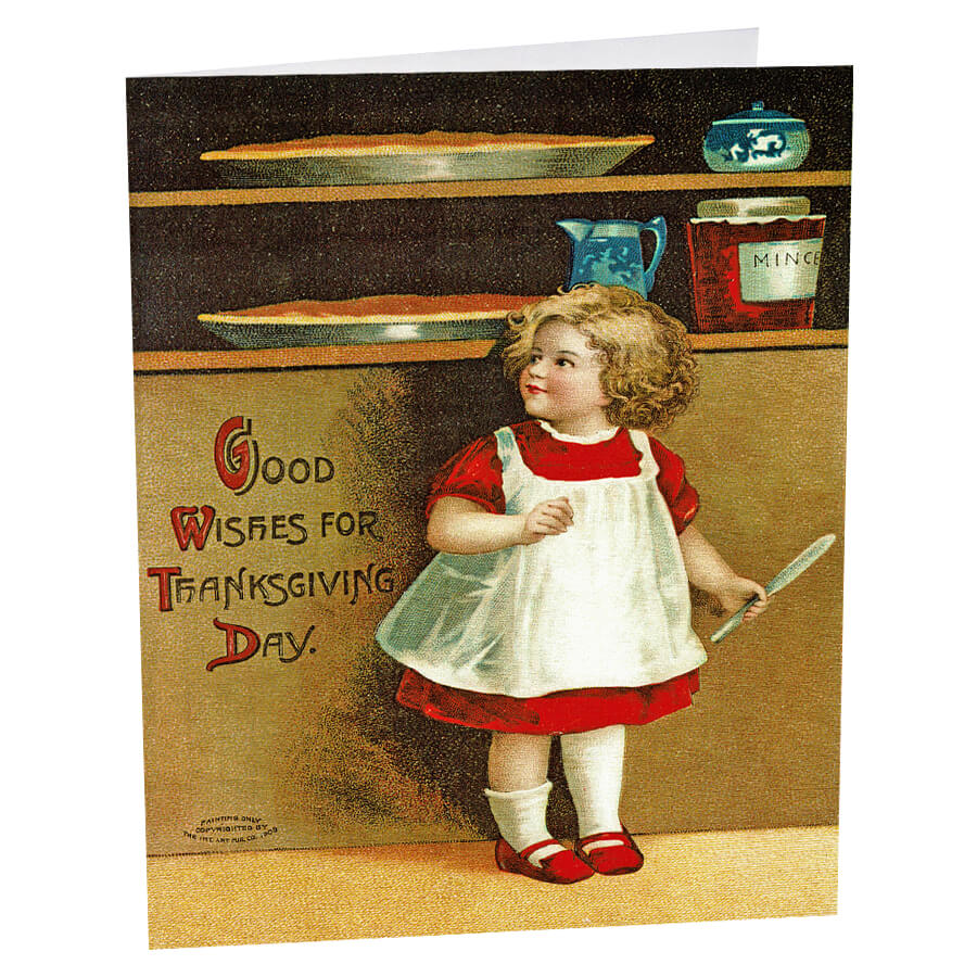 A young child in a red dress and white apron holding a knife, standing in a kitchen setting.