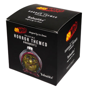 Black box with len simon designed babushka witch glass ornament featuring gold face and red headscarf by kurt adler