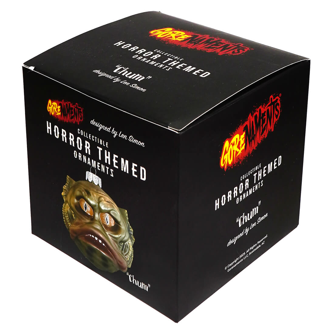 Black box showing gorenaments chum halloween ornament with greenish golden textured mask and orange eyes pumpkin ornament