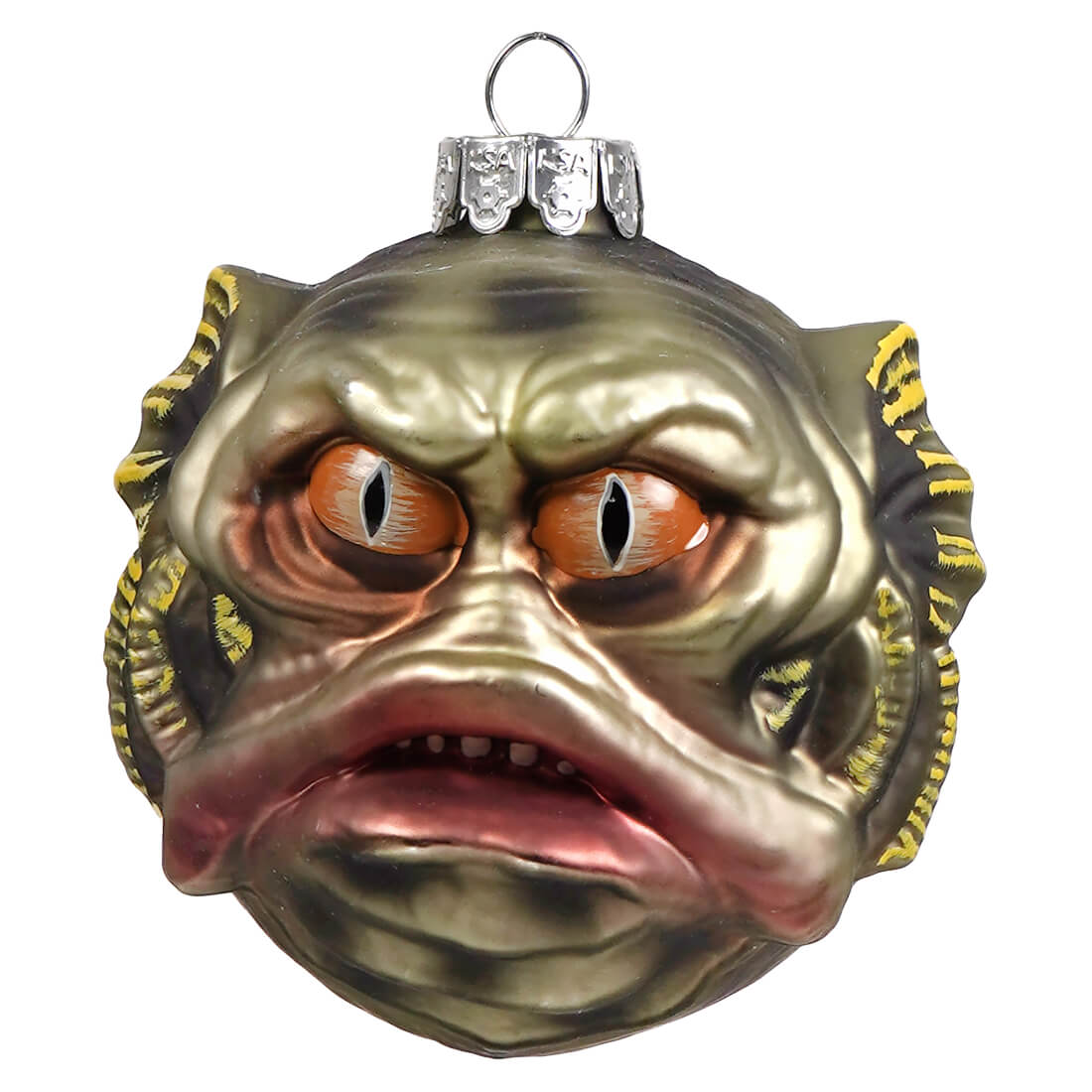 A glossy green and yellow glass halloween ornament shaped like chom the swamp monster with orange eyes and pink lips