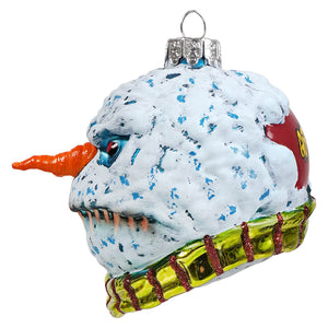 A whimsical evil snowman glass ornament by kurt adler with blue speckled face orange nose and green glittery scarf