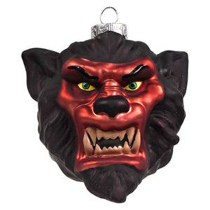A menacing red and black glass werewolf glass ornament with glowing green eyes and silver hanging loop by kurt adler