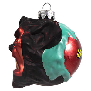 A glossy multicolored glass ornament shaped like a screaming face with black red and teal splatters werewolf glass ornament by kurt adler