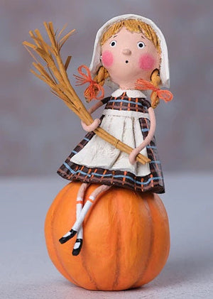 A lori mitchell grateful greta figurine of a blonde girl in plaid dress sitting on a pumpkin with a straw broom from esc & company thanksgiving pilgrims and indians figural decor