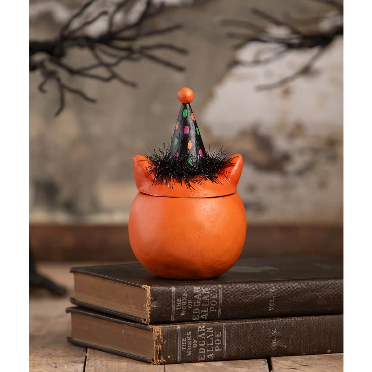 Orange ceramic witchs cauldron with black polka dot hat and fuzzy trim for halloween cats green eyed copper cat decor