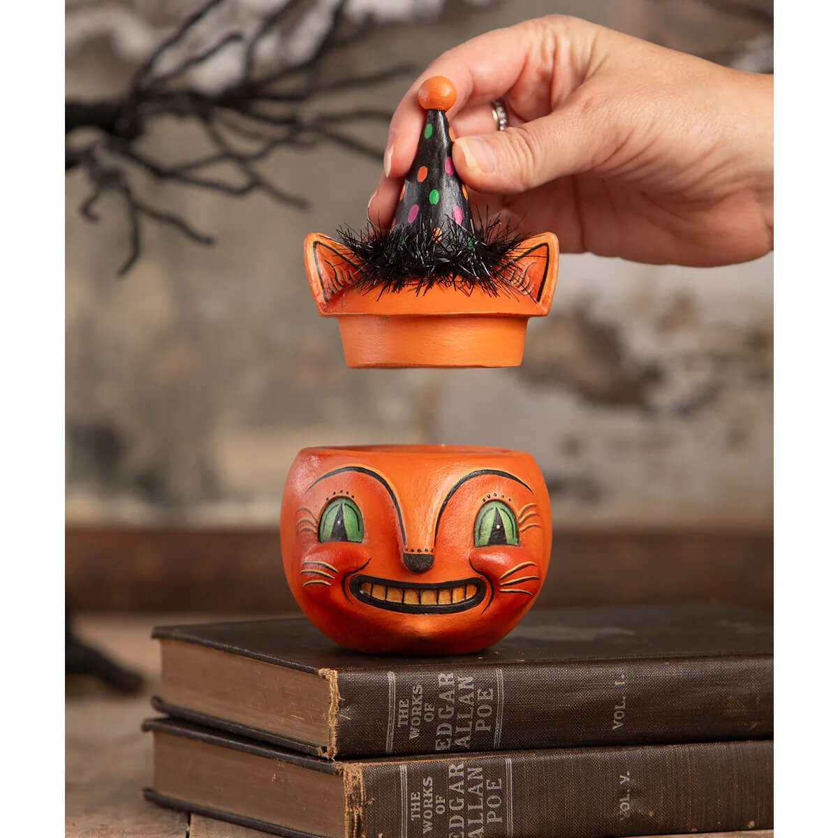 Orange ceramic cat-shaped candy dish with green eyes and a black polka-dotted hat perfect for halloween cats decor