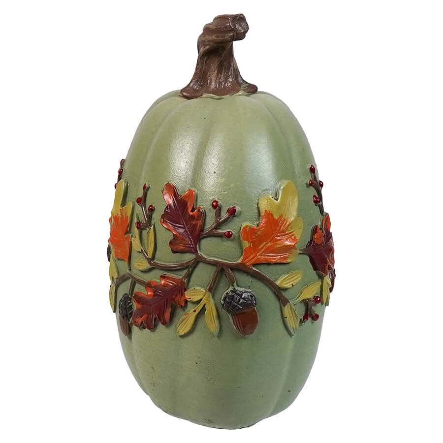 Decorative green pumpkin-shaped ornament with autumn leaf and acorn designs around the middle.