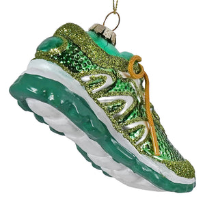 A glittery green running shoe ornament with white details gold laces and a metallic hanging loop for decoration