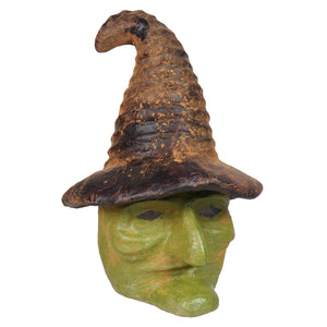 A weathered green witch head mask with a tall brown hat and black eye slits perfect for halloween witches decor