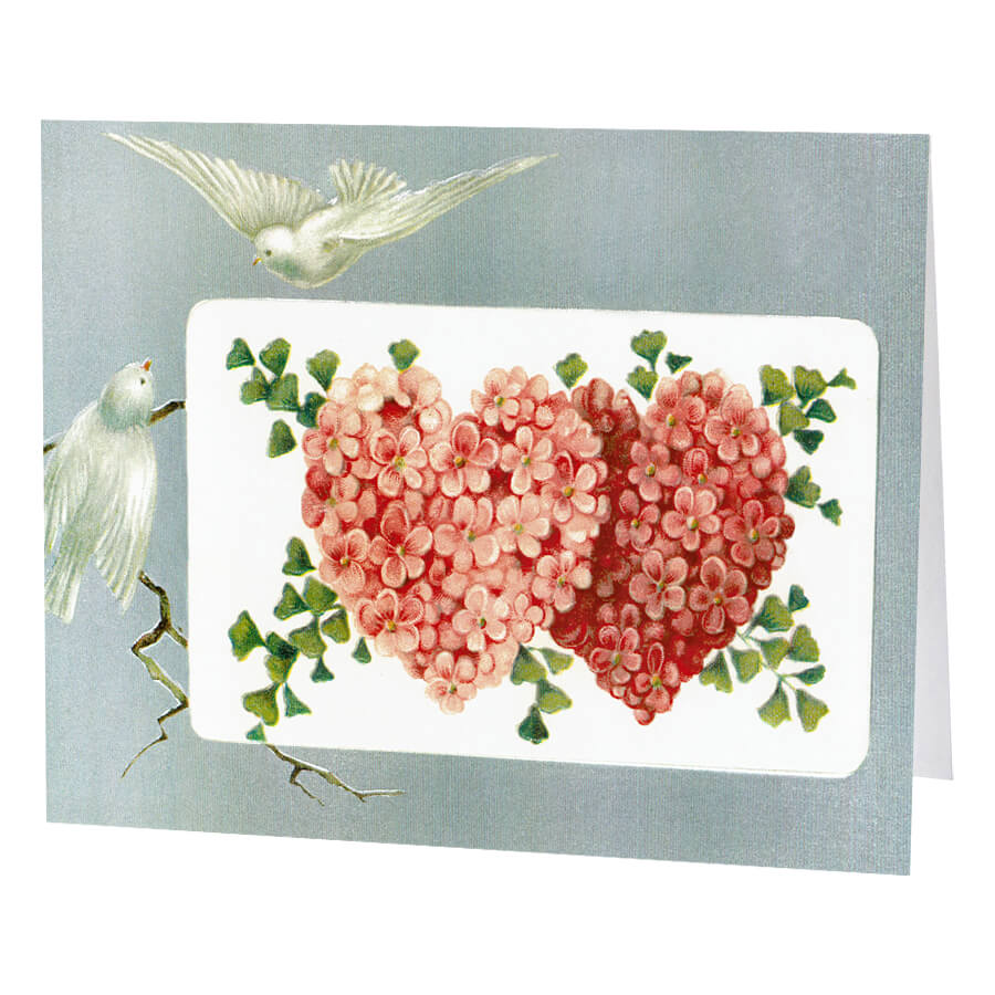 Greeting card featuring two floral hearts and white doves.