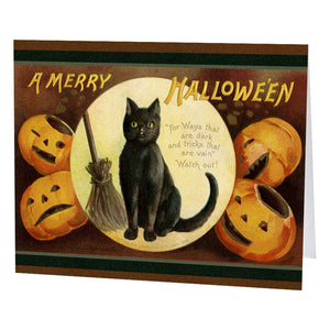 Black cat with yellow eyes holding a broomstick on cotton paper greeting card surrounded by carved pumpkins