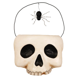 Beige plastic skull shaped grim bucket halloween treat bag with black eyes and glittery spider handle for skeleton decor figures and ornaments