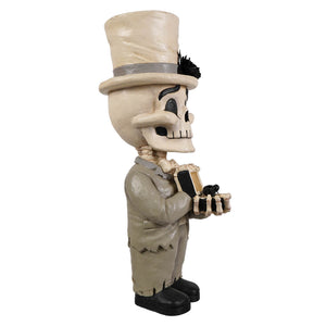 Beige skeleton decor figure groom mortimer skelly wearing a top hat and suit holding a box with black gemstone inside