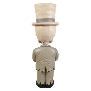 Beige skeleton decor figure skelly wearing a top hat and suit with black shoes called groom mortimer skelly