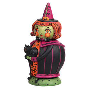 A whimsical halloween witch figurine with pink hat and green face holding a black cat from the jack spooks jar collection