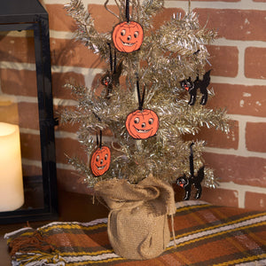 A halloween mini ornament set featuring a silver tinsel tree with orange pumpkin and black cat mini ornaments wrapped in burlap