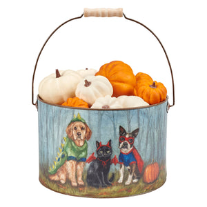 A festive halloween family bucket metal bucket with painted dogs and cat holding orange and white faux pumpkins inside