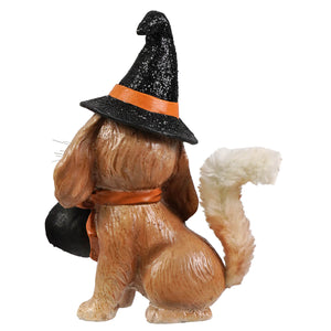 A brown furry dog figurine wearing a black glittery witch hat with an orange band holding a bag halloween frankie bethany lowe design