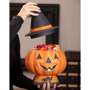 Orange halloween jack o lantern candy bucket shaped like a pumpkin with a black witch hat lid and cat silhouette base