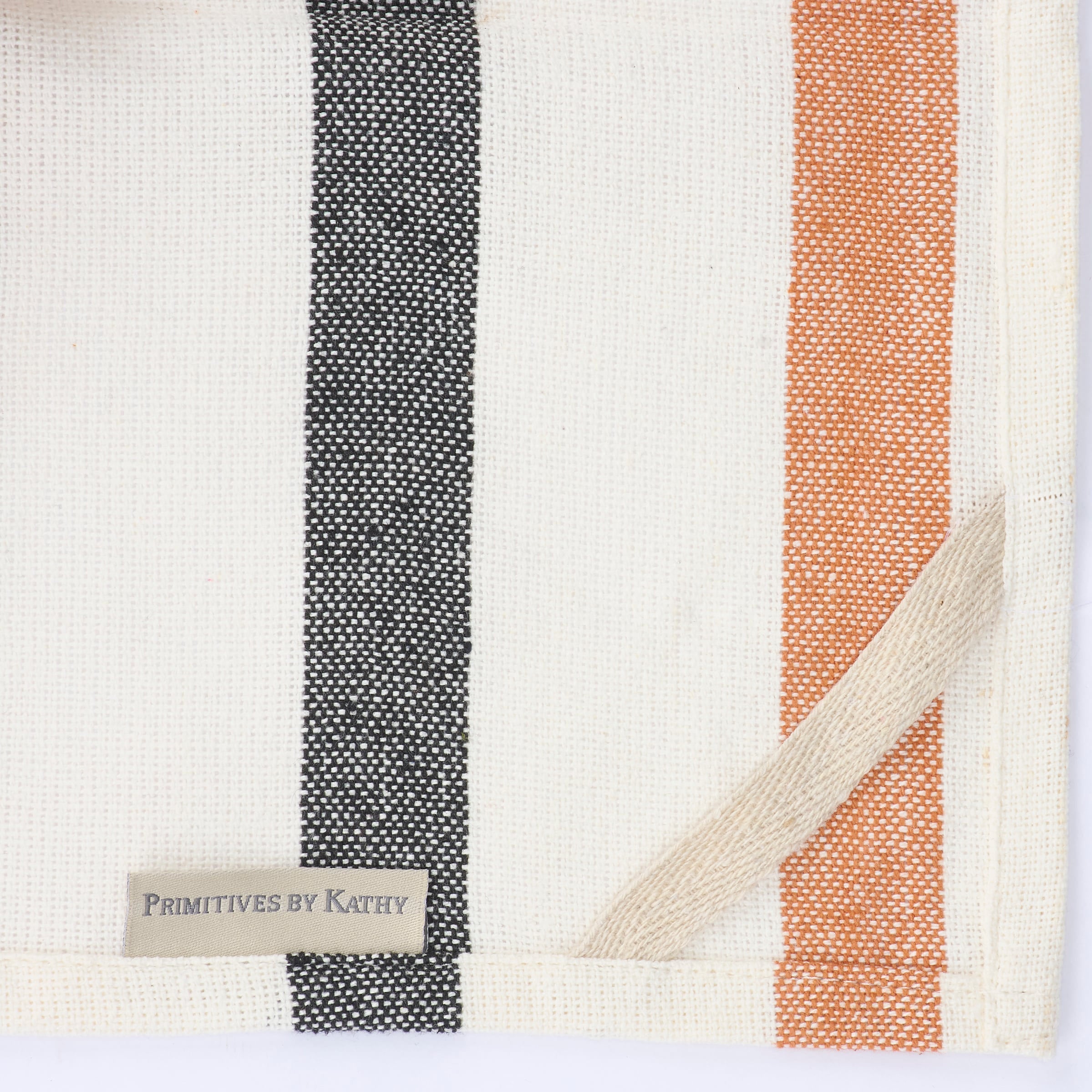 A woven cotton halloween stripe kitchen towel with bold black terracotta orange and cream stripes for breakfast inn kitchen use