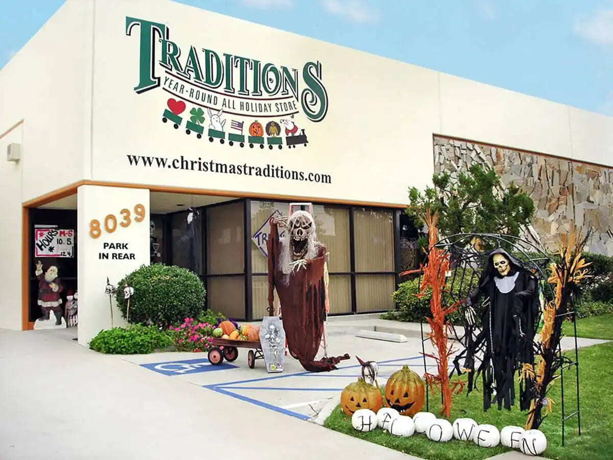 A Halloween-themed retail store called ’Traditions’ with seasonal decorations displayed outside.